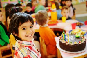 child at birthday party smiling
