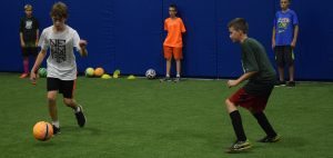 kids playing soccer at the zone