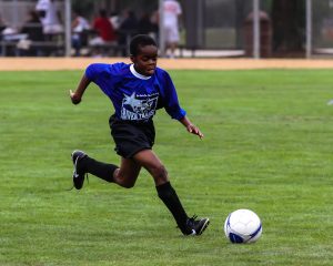 kid playing outdoor soccer