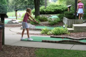 girl playing mini-golf