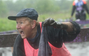 woman running the obstacle course race having fun