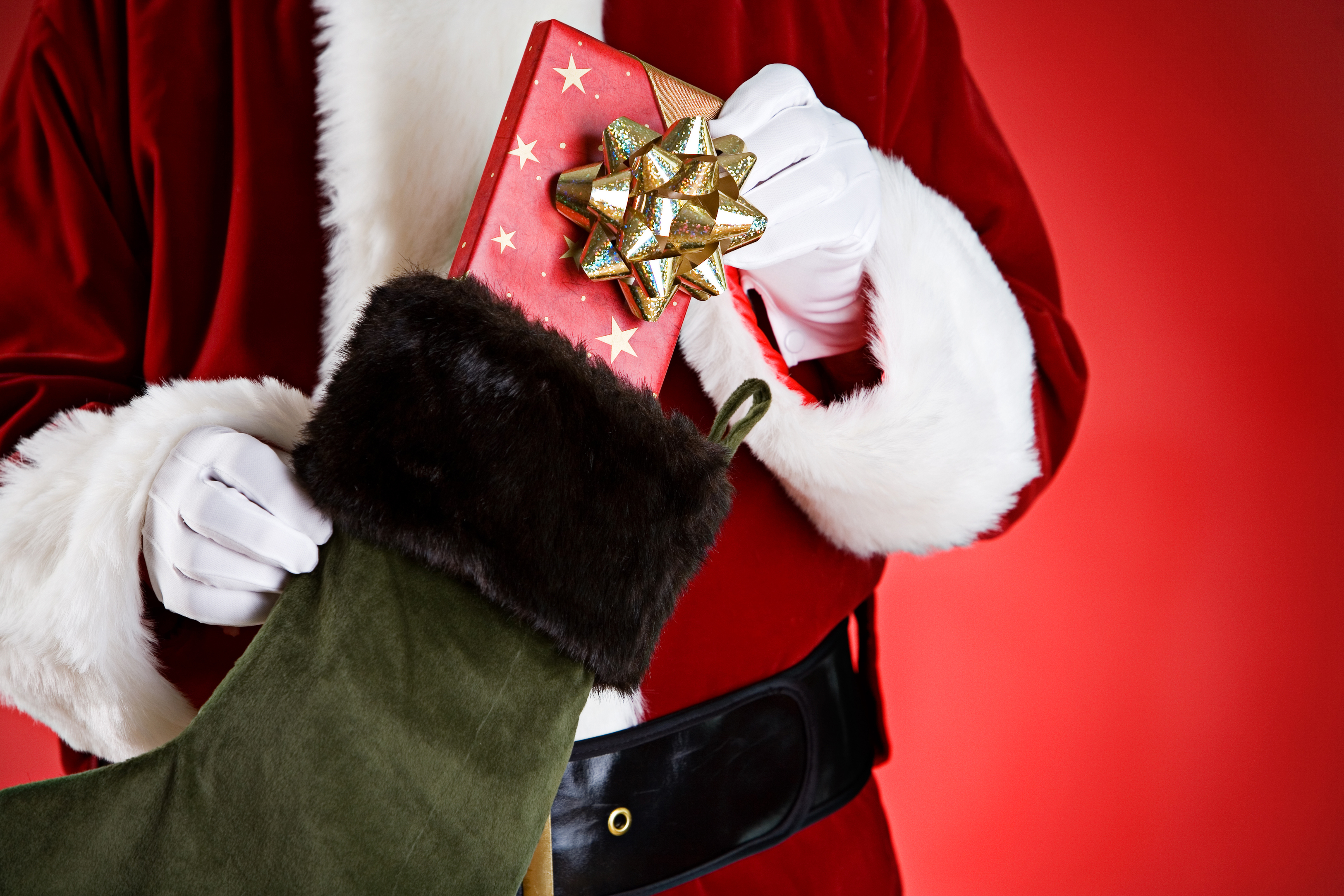 santa putting gift into stocking