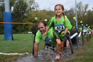 child running in obstacle course race