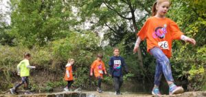 kids competing in obstacle course race having fun