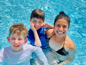 Mom and 2 sons happy in pool